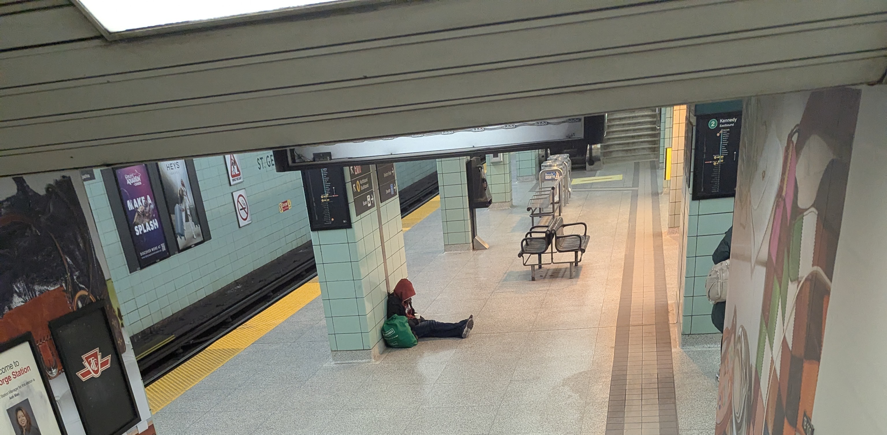 Person laying on the floor of a TTC station.
