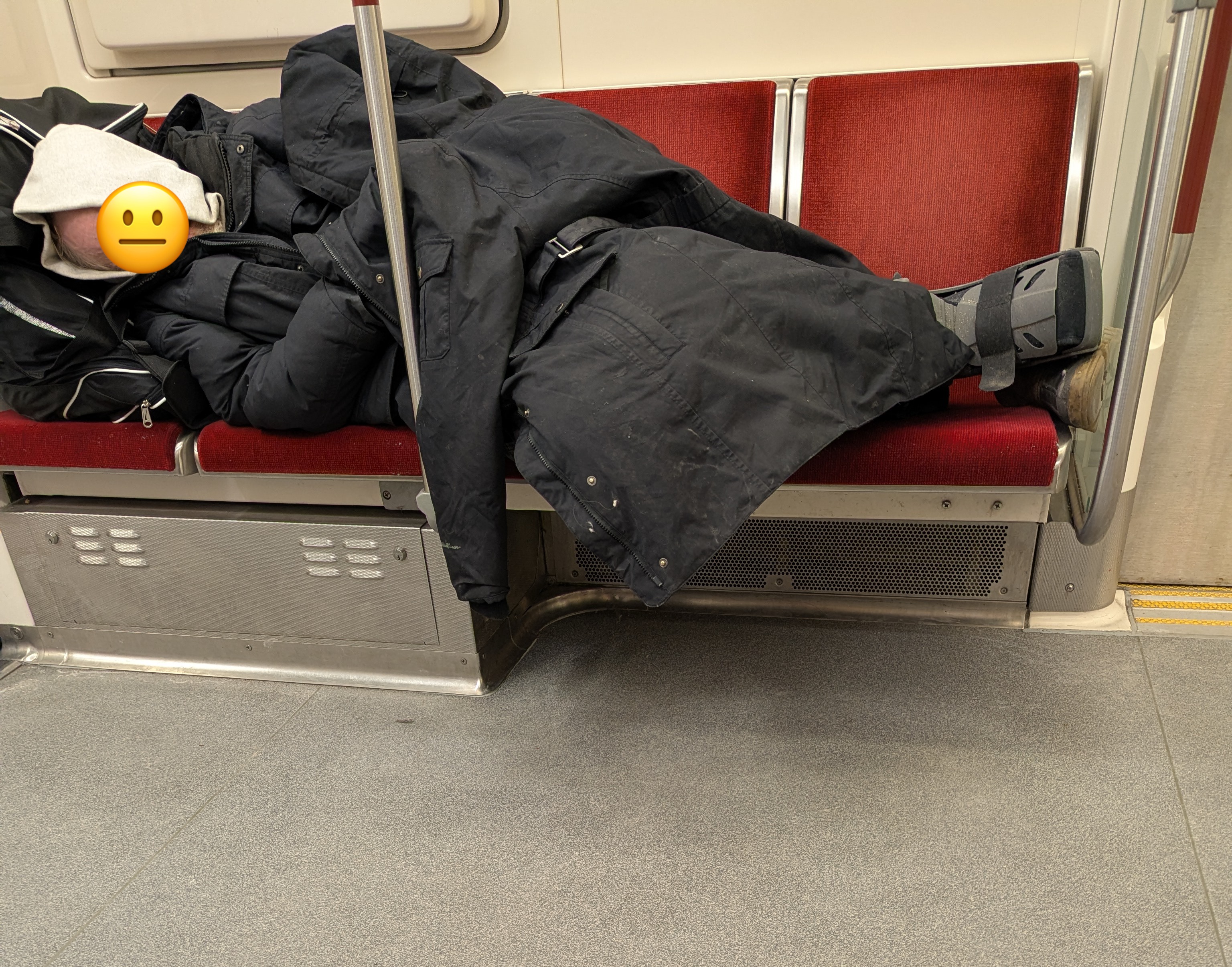 Man sleeping on TTC bench. 