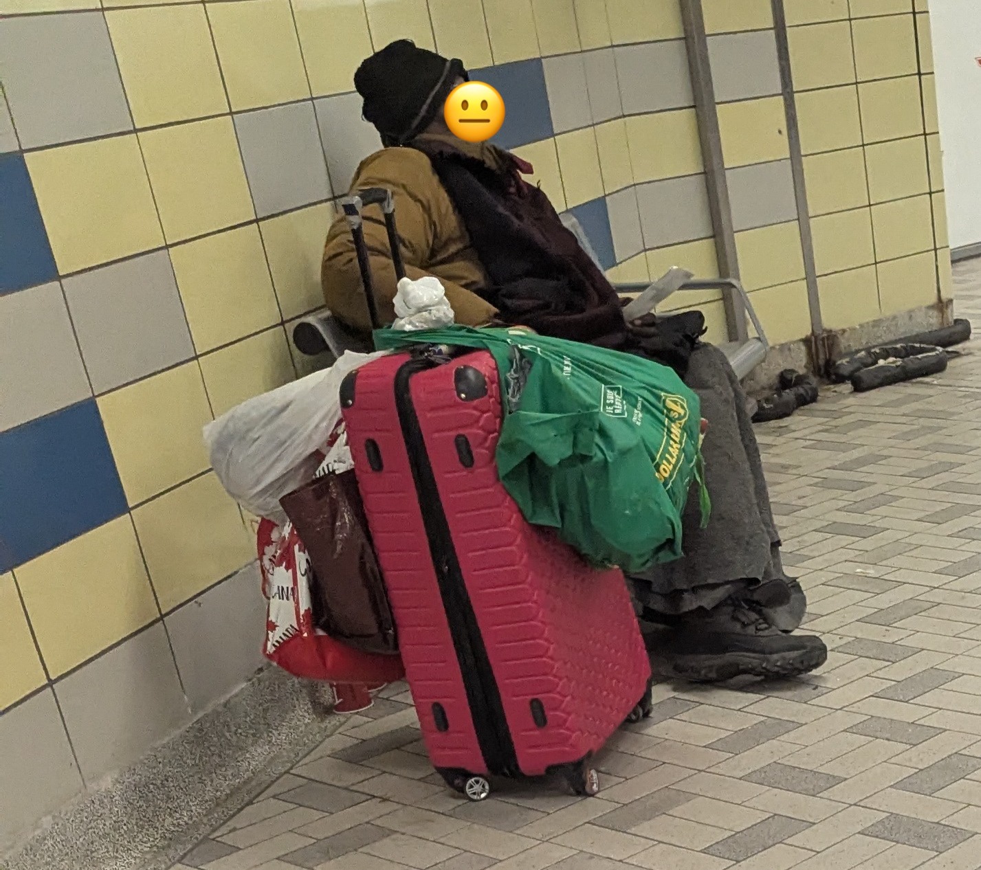 Man asking passersby for change.